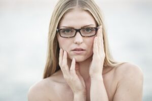 woman-hand on cheak by her ear